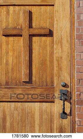 Stock Image - Cross on wooden door. Fotosearch