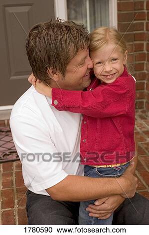 Stock Image - Daughter hugs father. Fotosearch