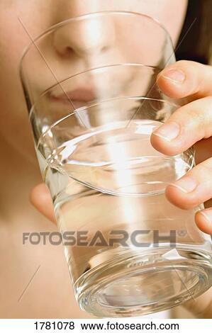 Stock Photo - Drinking a glass of water. Fotosearch