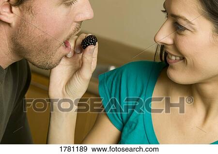 Eating a large berry View Large Photo Image Stock Photo - Eating a large berry. Fotosearch