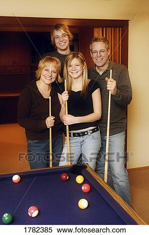 Stock Photography - Family playing a pool game. Fotosearch