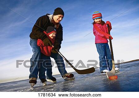 Family playing hockey View Large Photo Image Picture - Family playing hockey. Fotosearch