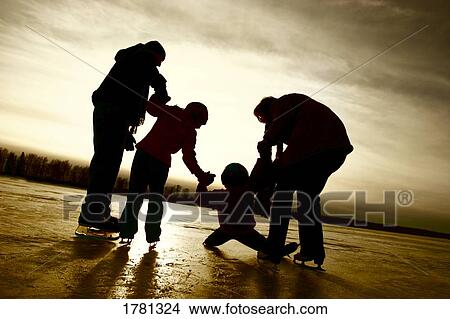Picture - Family skating together. Fotosearch