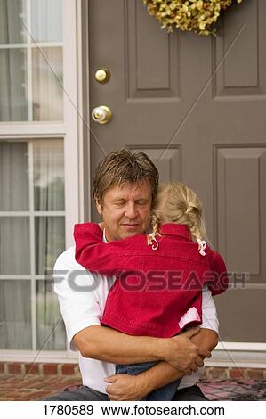 Stock Photo - Father hugs daughter. Fotosearch