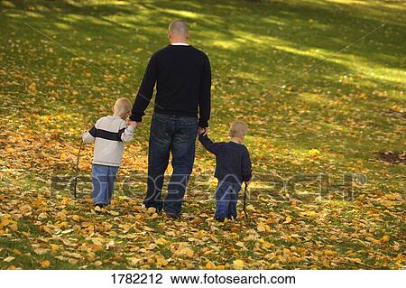 Stock Image - Father with two boys. Fotosearch