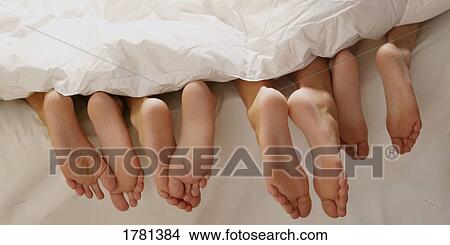 Picture - Feet in bed. Fotosearch