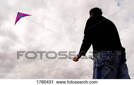 Flying a kite View Large Photo Image Stock Image - Flying a kite. Fotosearch