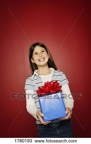 Stock Image - Girl holding present. Fotosearch