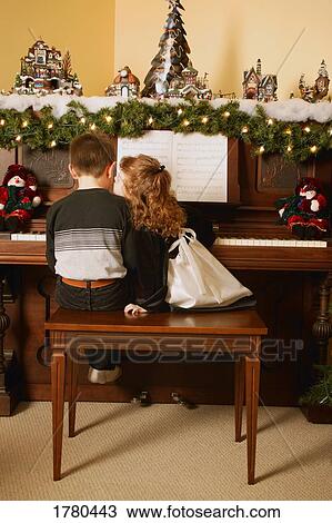 Girl kisses boy playing piano View Large Photo Image Stock Image - Girl kisses boy playing piano. Fotosearch