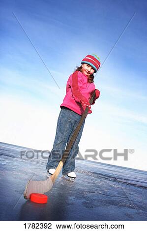 Stock Image - Girl with hockey stick. Fotosearch
