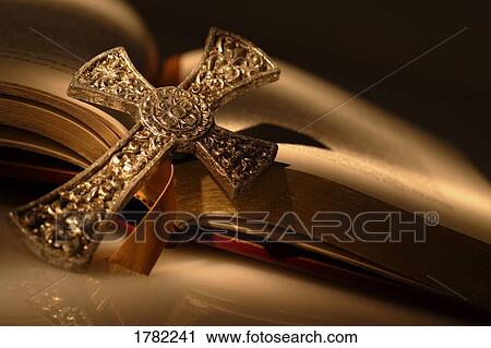 Gold cross on open bible View Large Photo Image Stock Image - Gold cross on open bible. Fotosearch