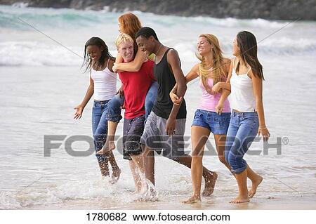 Stock Image - Group of teenagers at the beach. Fotosearch