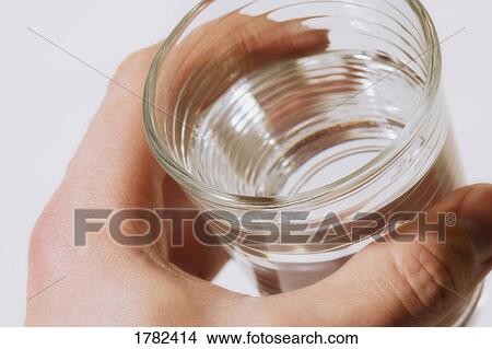 Holding a cup of water View Large Photo Image Picture - Holding a cup of water. Fotosearch