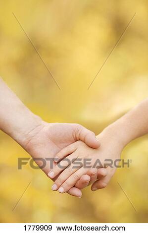 Holding hands View Large Photo Image Stock Photo - Holding hands. Fotosearch