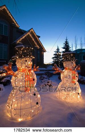Illuminated snowmen outside house View Large Photo Image Picture - Illuminated snowmen outside house. Fotosearch