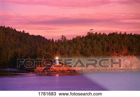 Lighthouse on rocky shore View Large Photo Image Stock Image - Lighthouse on rocky shore. Fotosearch