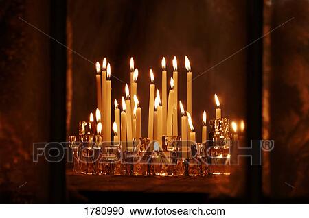 Stock Image - Lit candles. Fotosearch