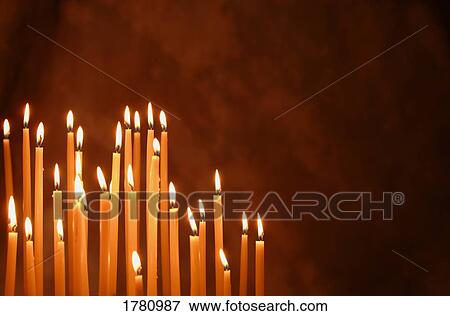 Stock Photo - Lit candles. Fotosearch