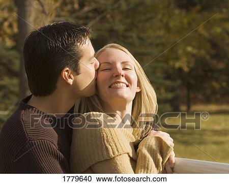 Man kisses woman's face View Large Photo Image Stock Image - Man kisses woman's face. Fotosearch