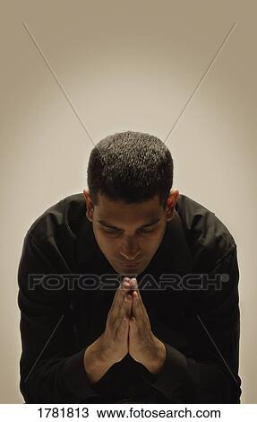 Stock Image - Man praying. Fotosearch