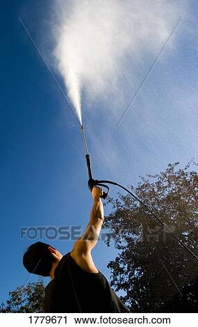 Man with pressure washer View Large Photo Image Stock Image - Man with pressure washer. Fotosearch