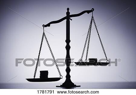 Stock Image - Money on a scale. Fotosearch