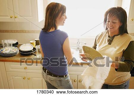 Mother and daughter doing dishes together View Large Photo Image Stock Image - Mother and daughter doing dishes together. Fotosearch