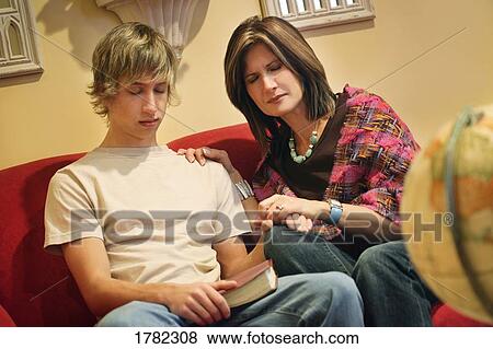 Stock Photo - Mother and son praying together. Fotosearch