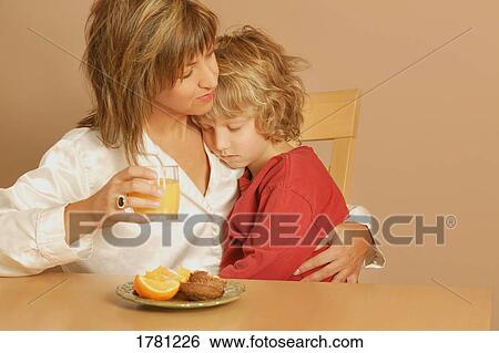 Stock Photograph - Mother holds sleepy child. Fotosearch
