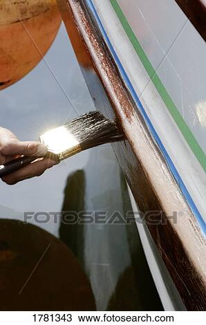 Stock Image - Painting a boat. Fotosearch