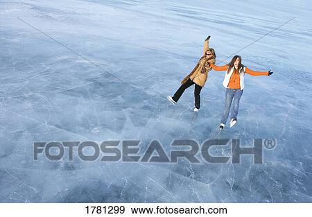 Stock Photo - Pair going ice skating. Fotosearch