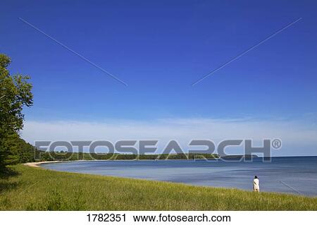 Person looking out at water in bay View Large Photo Image Stock Image - Person looking out at water in bay. Fotosearch
