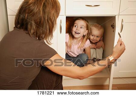 Playing hide-and-go-seek View Large Photo Image Stock Image - Playing hide-and-go-seek. Fotosearch