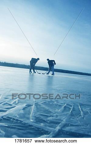 Playing hockey on a frozen lake View Large Photo Image Stock Photo - Playing hockey on a frozen lake. Fotosearch