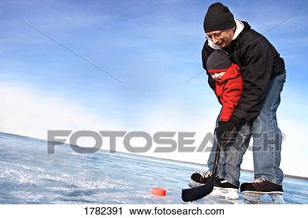 Stock Image - Playing hockey together. Fotosearch