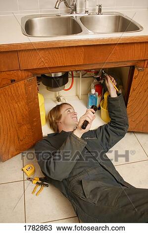 Plumber fixing the sink View Large Photo Image Stock Image - Plumber fixing the sink. Fotosearch
