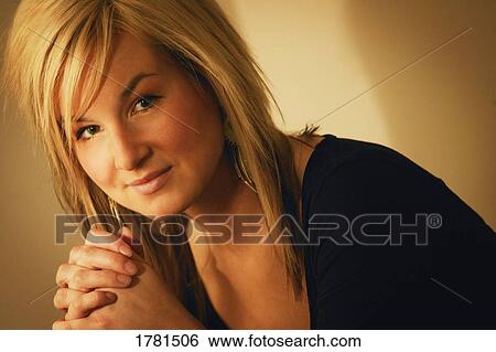 Stock Photograph - Portrait of a woman praying. Fotosearch