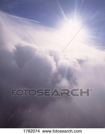 Picture - Sunburst through cloud tops. Fotosearch