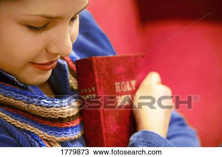 Teen holds Bible and prays View Large Photo Image Stock Image - Teen holds Bible and prays. Fotosearch
