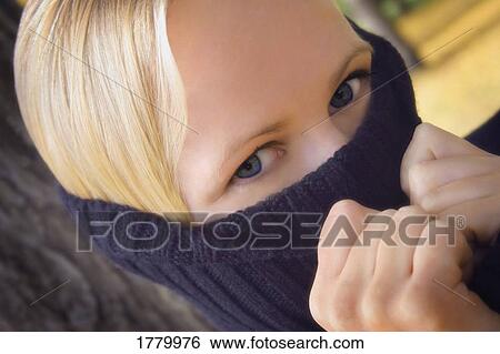 Stock Photograph - Teenager hides under turtleneck. Fotosearch