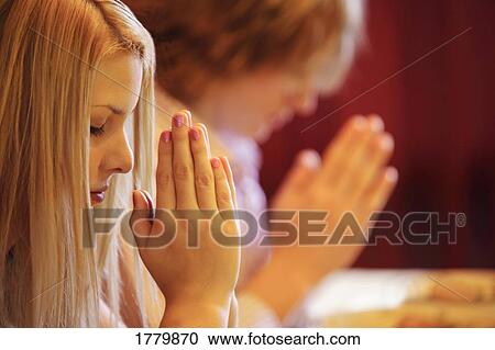 Stock Image - Teens praying. Fotosearch