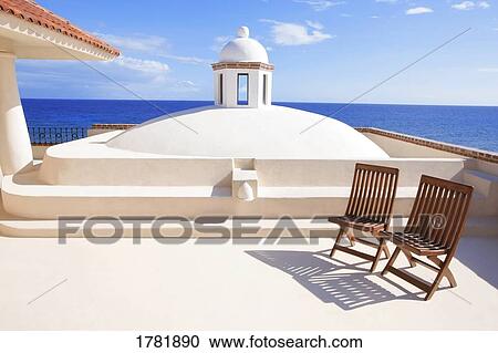 Two chairs waiting in a tropical paradise View Large Photo Image Stock Image - Two chairs waiting in a tropical paradise. Fotosearch