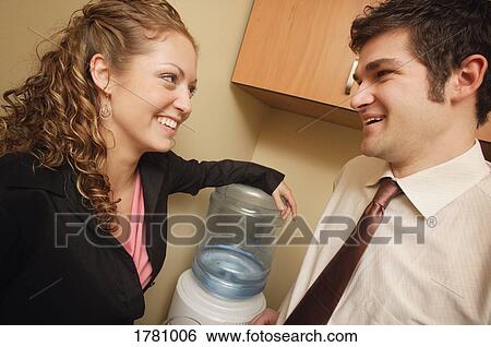 Stock Photograph - Water cooler talk. Fotosearch