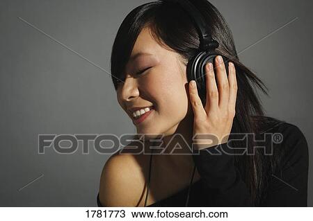 Woman listening with headphones View Large Photo Image Stock Image - Woman listening with headphones. Fotosearch