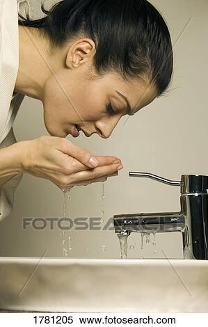 Woman washing her face View Large Photo Image Stock Photography - Woman washing her face. Fotosearch
