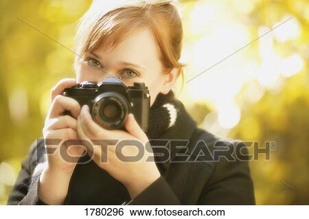 Stock Photograph - Woman with a camera. Fotosearch
