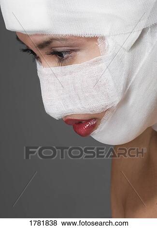Stock Photo - Woman with bandages on her face. Fotosearch