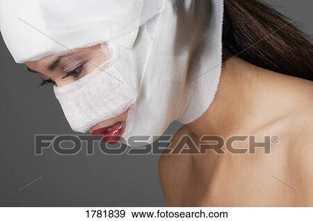 Woman with bandages on her face View Large Photo Image Stock Photo - Woman with bandages on her face. Fotosearch