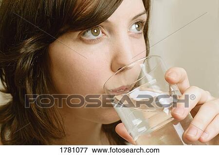 Young girl drinking water View Large Photo Image Stock Photo - Young girl drinking water. Fotosearch
