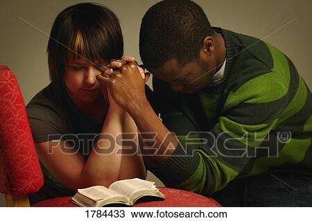 A couple praying together View Large Photo Image Stock Image - A couple praying together. Fotosearch